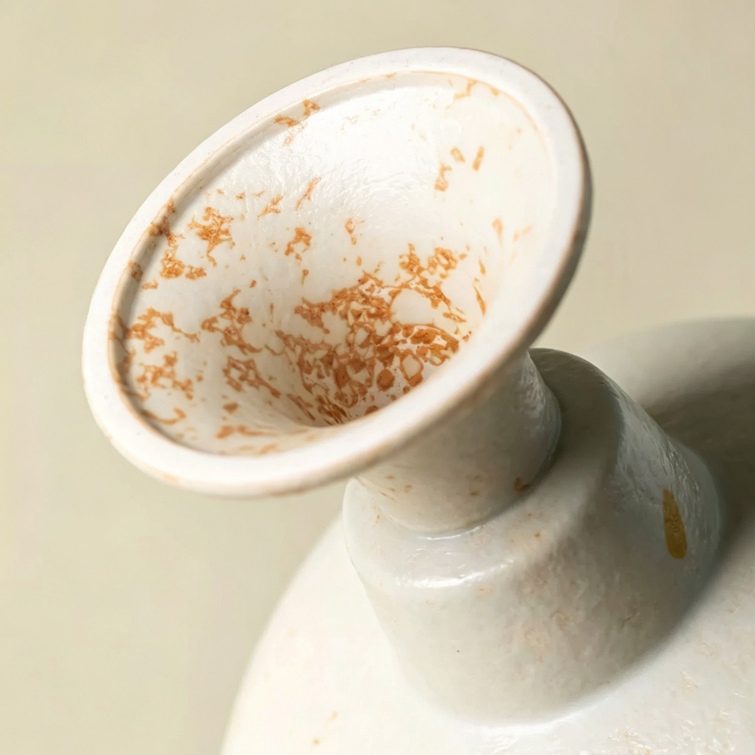 Close-up of hand-painted rapeseed floral patterns on vintage ceramic burner