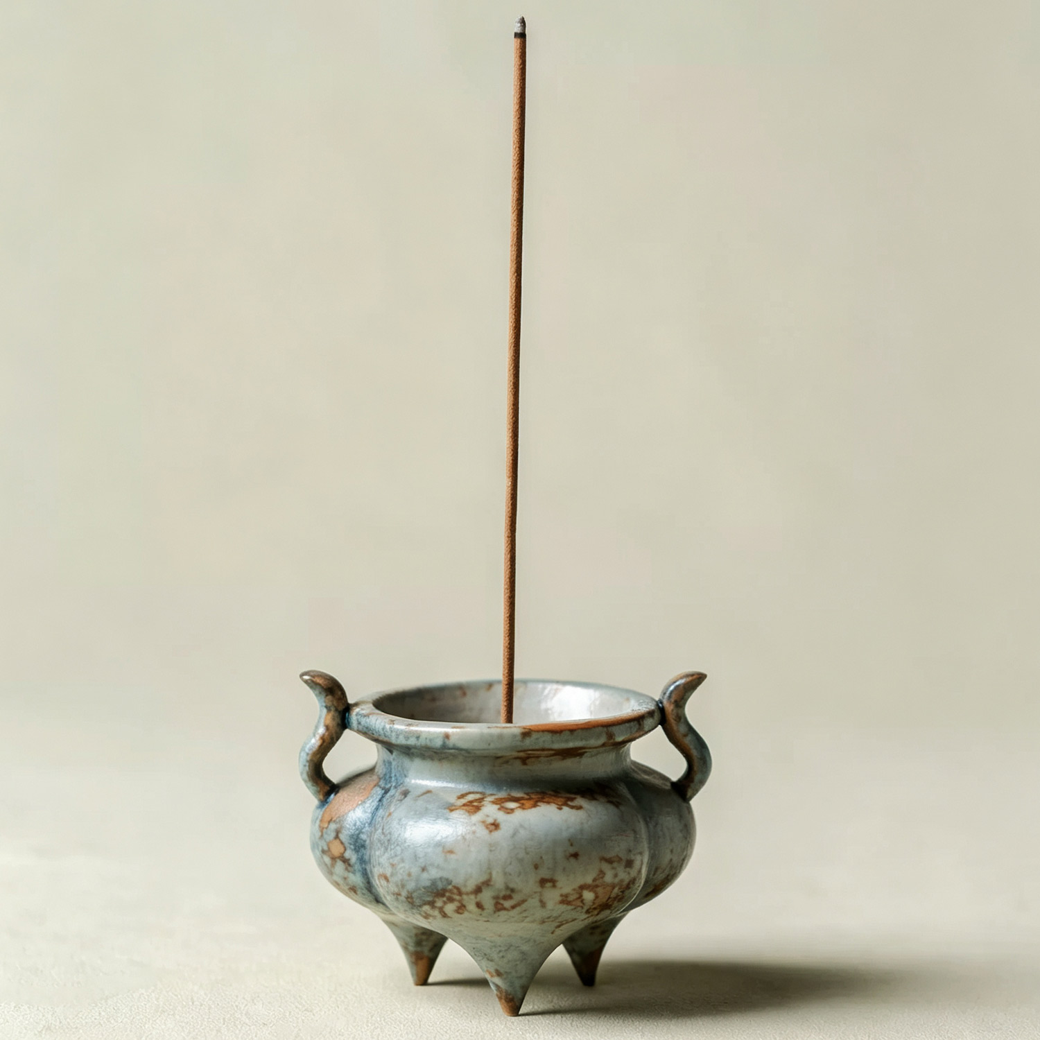 Traditional oriental tripod censer with curved side handles for tea table
